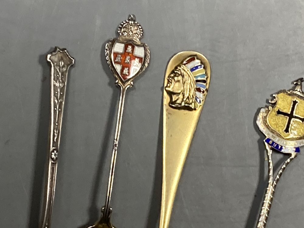 Six 20th century assorted silver and enamel souvenir spoons, gross 81 grams and five similar white metal and enamel spoons,